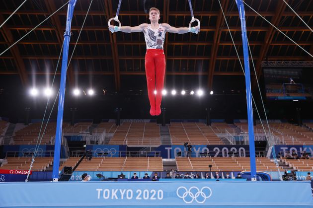 Shane Wiskus of Team USA, who said he doesn't mind the crowdless factor, competes on rings during men's qualification.