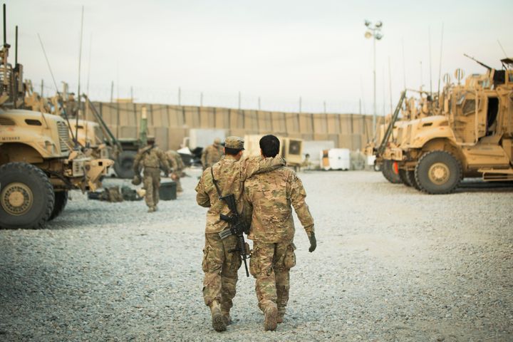 In this 2014 file photo, a U.S. soldier from the 3rd Cavalry Regiment walks with the unit's Afghan interpreter before a mission near forward operating base Gamberi in the Laghman province of Afghanistan.