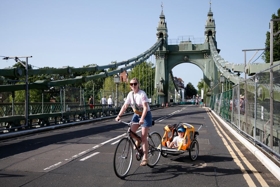 A cyclist rides over Hammersmith Bridge on July 17. The bridge was closed last year after cracks in the bridge worsened during a heatwave