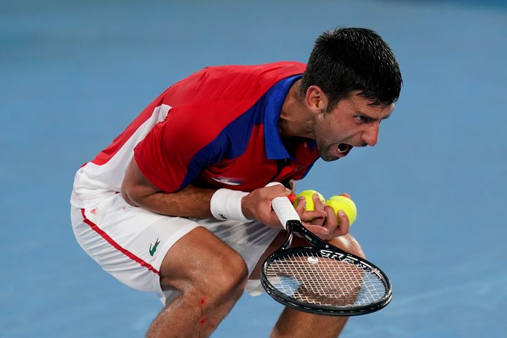 Novak Djokovic, of Serbia, reacts during a semifinal men's tennis match against Alexander Zverev, of Germany, at the 2020 Summer Olympics on July 30, 2021, in Tokyo, Japan. 