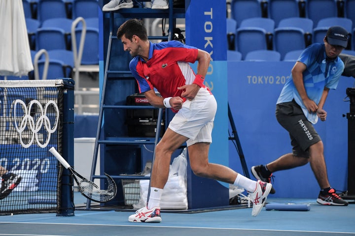 Serbia's Novak Djokovic smashes his racket during his Tokyo Games men's singles tennis match for the bronze medal against Spa
