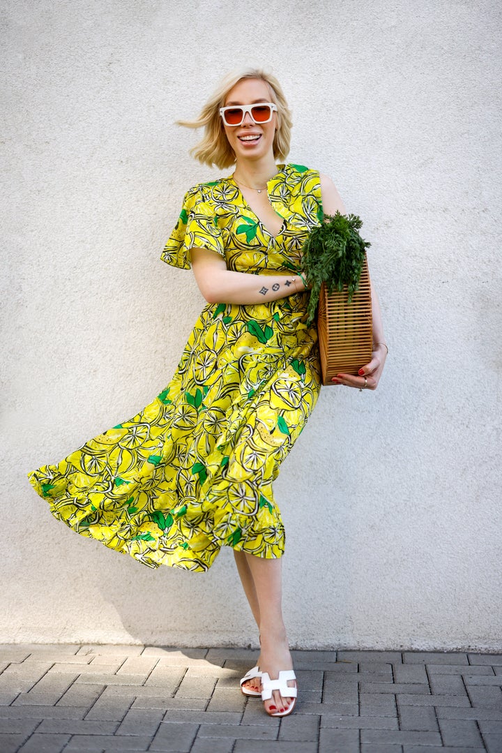 Hairstylist Svenja Simmons wearing a yellow lemon-print top and matching skirt from Diane von Furstenberg during a street style shoot in Dusseldorf, Germany, on June 4, 2021.