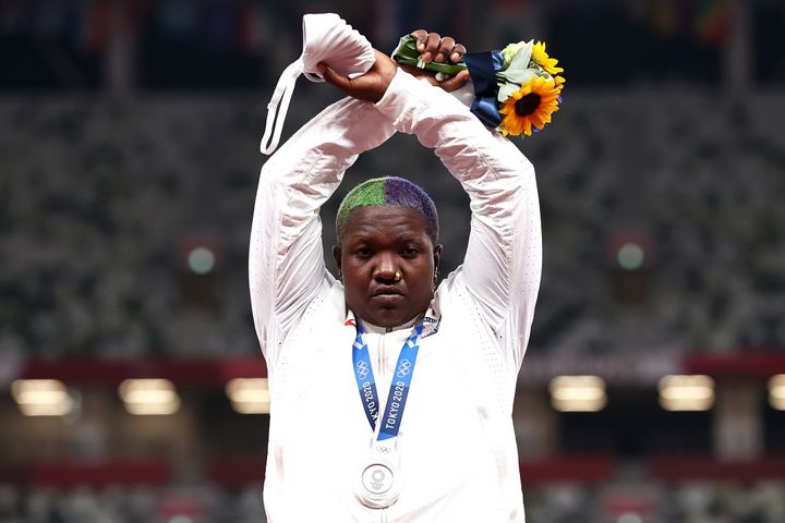 Raven Saunders raises her arms in an "X" on the Olympic podium.