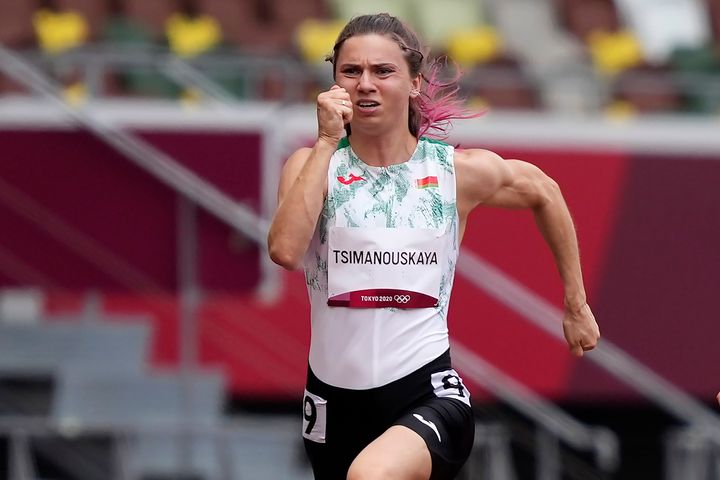 Krystsina Tsimanouskaya, of Belarus, runs in the women's 100-meter run at the 2020 Summer Olympics on July 30. Tsimanouskaya has alleged that her Olympic team tried to remove her from Japan, leading to a standoff Sunday at Tokyo's main airport.