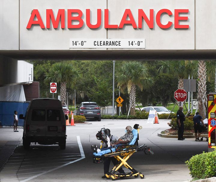 A patient is brought on a gurney to the emergency department at AdventHealth hospital in Orlando on July 26, the day that hospital officials reported they were elevating to level red with a full ICU and more than 900 patients hospitalized with COVID-19 in Central Florida. The hospital system's inpatient totals have been raised to near January's record as the delta variant infects unvaccinated people.