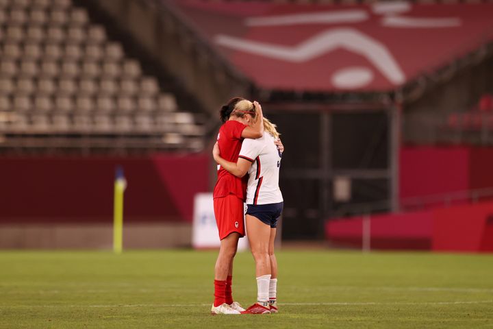 Lindsey Horan of the United States, right, is consoled by a Canadian player after Canada's 1-0 victory.