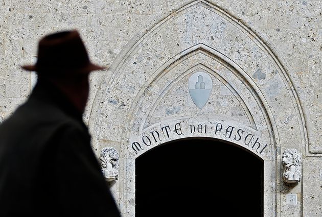 A man walks on January 25, 2013 past the headquarters of the Banca Monte dei Paschi di Siena (MPS), the...