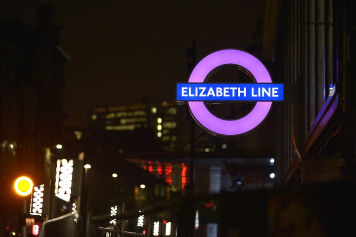 A new London Underground roundel for the Elizabeth Line is illuminated outside the new Crossrail station