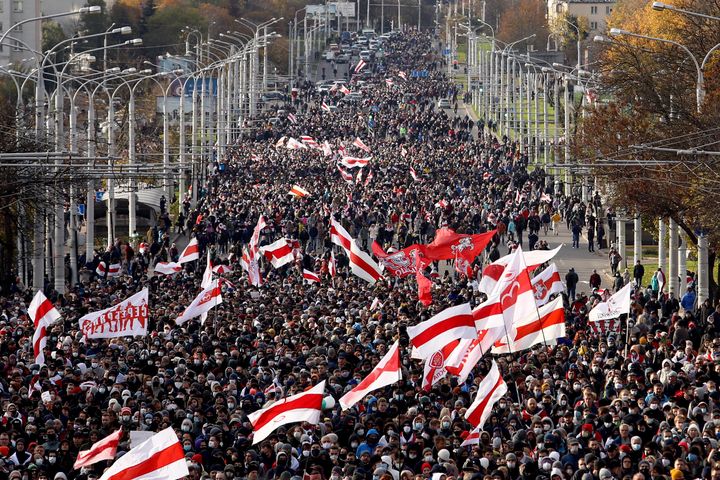 Opposition supporters parade through the streets during a rally to protest against the Belarus presidential election results in Minsk on October, 2020.