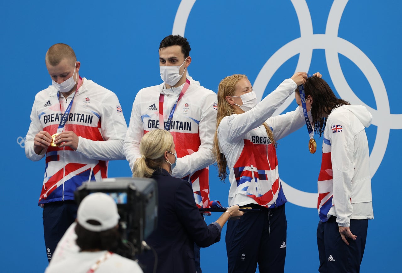 Anna Hopkin presents Kathleen Dawson of Team Great Britain with her medal during the ceremony for the mixed 4 x 100 meter medley relay on July 31.