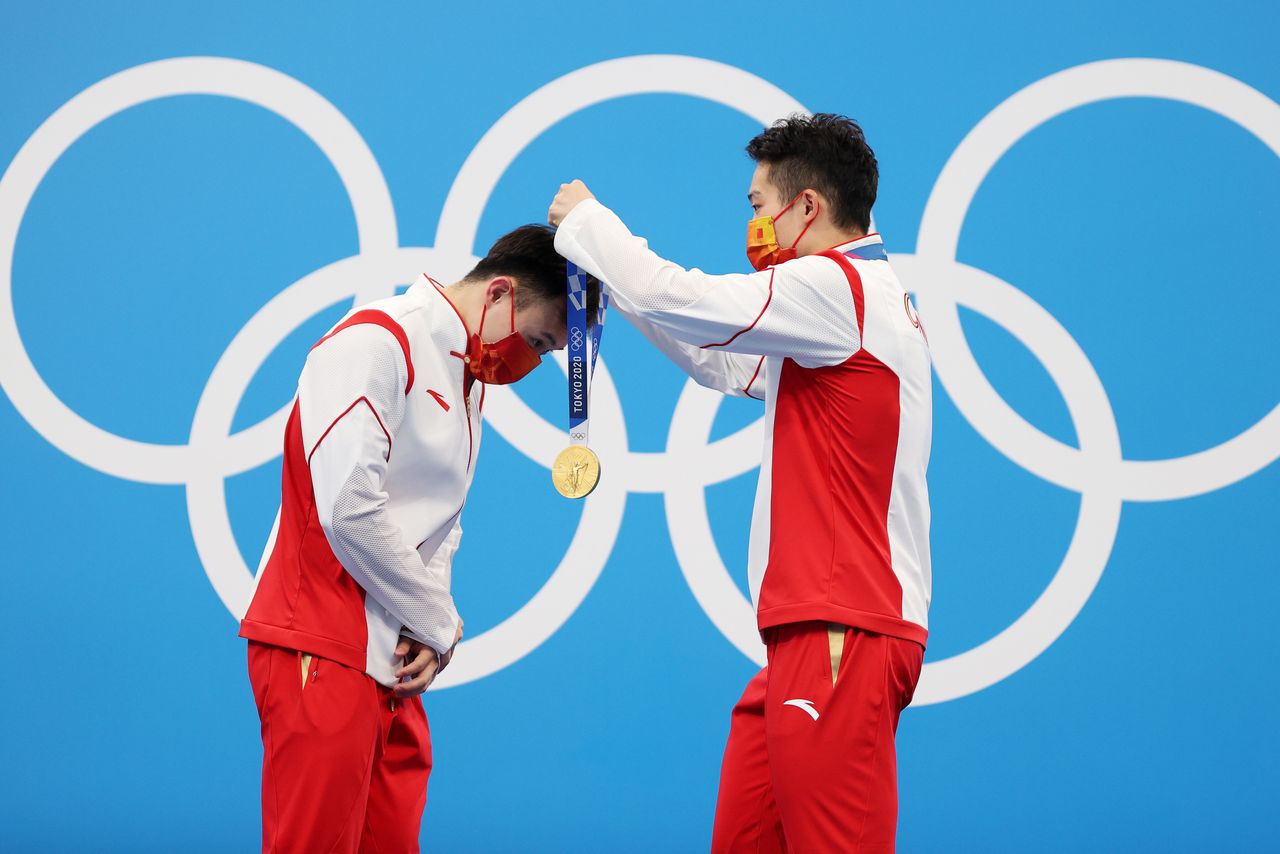 Gold medalists Zongyuan Wang and Siyi Xie of Team China during the medal ceremony for the men's synchronized 3 meter springboard diving final on July 28.