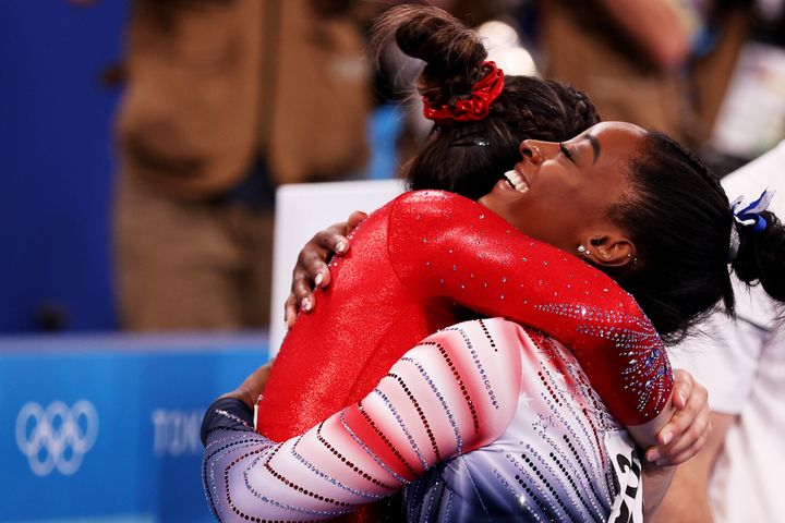 TOKYO, JAPAN - AUGUST 03: Simone Biles of Team United States embraces teammate Sunisa Lee during the Women's Balance Beam Final on day eleven of the Tokyo 2020 Olympic Games at Ariake Gymnastics Centre on August 03, 2021 in Tokyo, Japan. (Photo by Elsa/Getty Images)