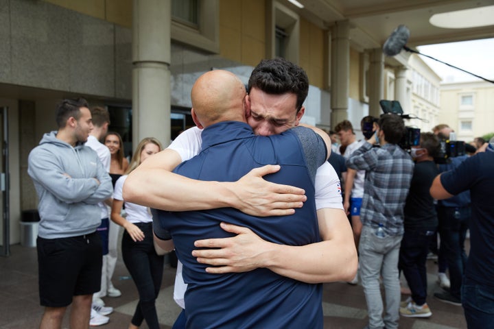 James Guy hugs his father Andrew Guy.