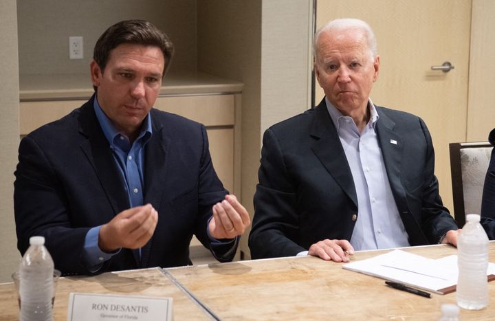 Florida Gov. Ron DeSantis (left) speaks about the collapse of the 12-story Champlain Towers South condo building in Miami alongside Biden on July 1.