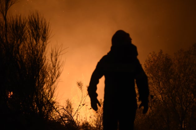 ATHENS, GREECE - AUGUST 03: Flames are seen at forestland after a forest fire at the area of Varybobi, northeastern suburb of Athens, Greece on August 03, 2021. A wildfire broke out Tuesday afternoon in a forest in the Varybobi area in the northeast of Greece's Attica region, spreading fast due to dry conditions in the area, the fire department said. (Photo by Dimitris Lampropoulos/Anadolu Agency via Getty Images)