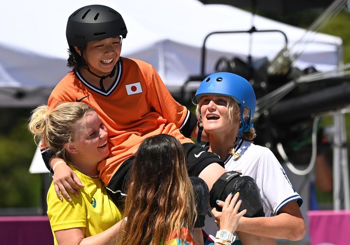 Okamoto Misugu is carried off after she fell on her last run in the skateboarding park final.