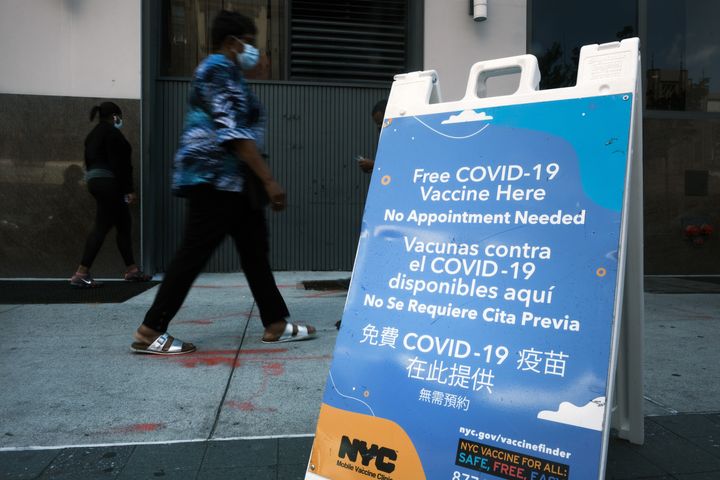 A city-operated mobile pharmacy advertises the COVID-19 vaccine in New York's Brooklyn neighborhood on July 30. Mayor Bill de Blasio has announced that the city will require all city workers to be vaccinated or tested weekly for COVID-19 and the city will now pay any individual $100 to get the shot. 