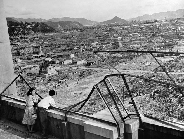 原爆投下後3年目の1948年に撮影された広島の町。一面の焼け野原にもぼつぼつ家が建てられている。ビルの屋上から2人連れが町を見下ろしている（日本・広島）