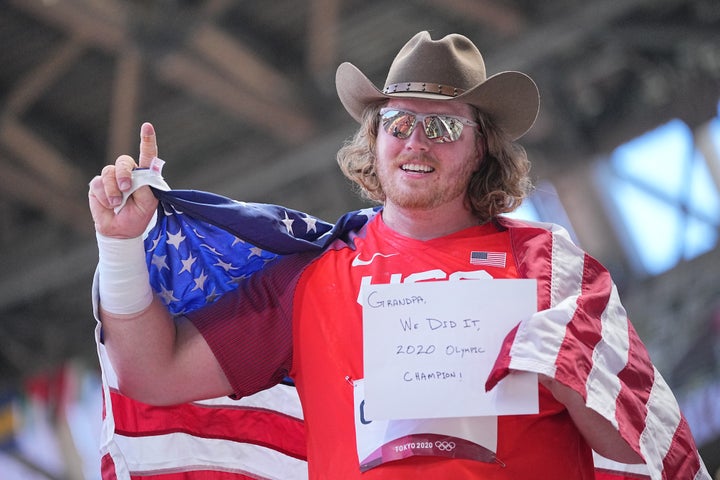 Ryan Crouser held up the sign during his lap of honor.