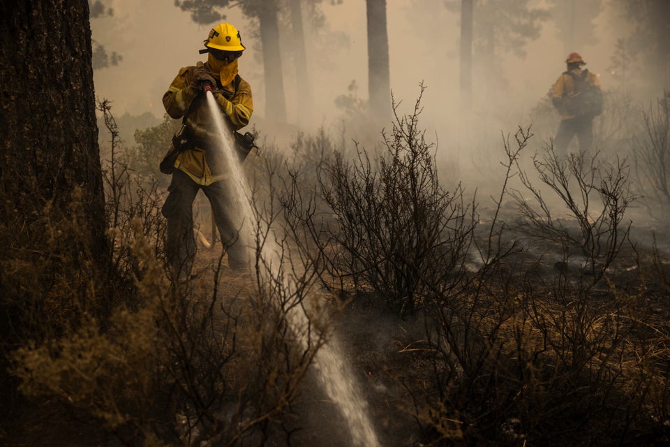 Firefighters extinguish a hot spot during the Dixie Fire in Chester,
