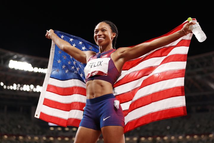 Allyson Felix of Team USA celebrates winning a bronze medal at the Olympics. 