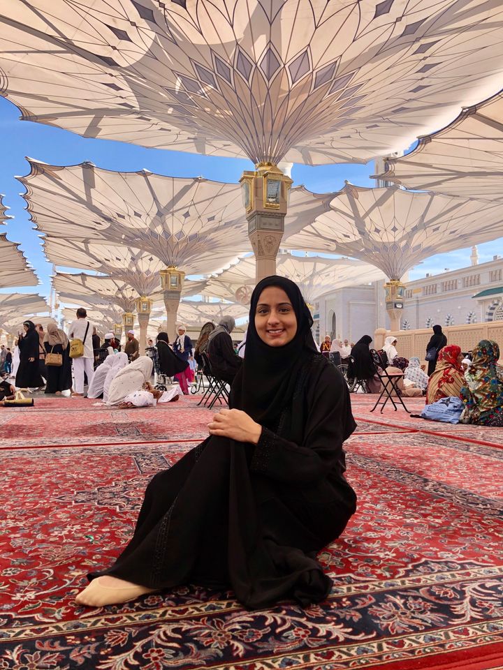 Farhana sits outside The Prophet's Mosque in Medina, Saudi Arabia.