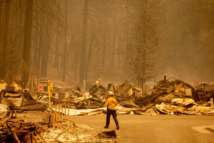 A firefighter surveys a destroyed downtown during the Dixie fire in Greenville, California on August 5, 2021