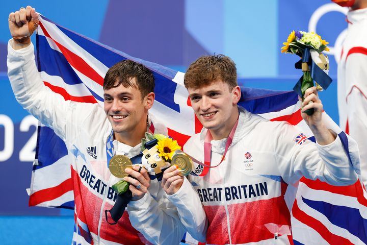 Tom Daley and Matthew Lee of Team Great Britain pose for photographers with their gold medals after winning the Men's Synchronised 10m Platform Final