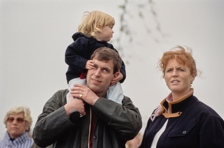 Princess Beatrice on Prince Andrew's shoulders, with Ferguson at right ht, at the Royal Windsor Horse Show in May 1990.