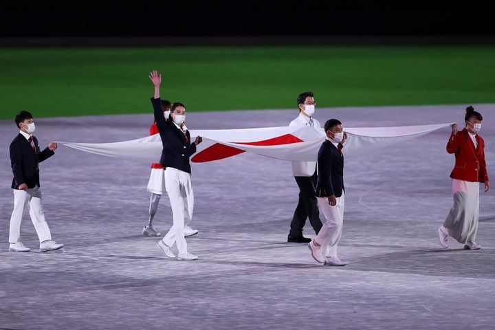 TOKYO, JAPAN - AUGUST 08: Judoka Takato Naohisa, Swimmer Ohashi Yui, Artistic Gymnast Kitazono Takeru, Breakdancer Kawai Ramu, Model Amane and Deputy chief medical officer Yokota Hiroyoki carry the Japanese national flag during the Closing Ceremony of the Tokyo 2020 Olympic Games at Olympic Stadium on August 08, 2021 in Tokyo, Japan. (Photo by David Ramos/Getty Images)