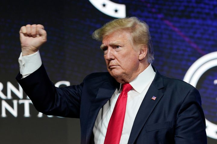 Former President Donald Trump pumps his fist to supporters after speaking at a Turning Point Action gathering in Phoenix on July 24.