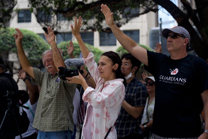 Anti-vaccine protesters pray outside of Houston Methodist Hospital in Houston, Texas, on June 26, 2021. More than 150 hospita