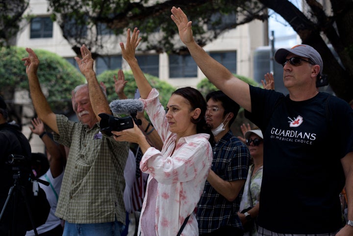 Anti-vaccine protesters pray outside of Houston Methodist Hospital in Houston, Texas, on June 26, 2021. More than 150 hospital staff were either fired or resigned after a judge dismissed their lawsuit regarding the institution's vaccine mandate.