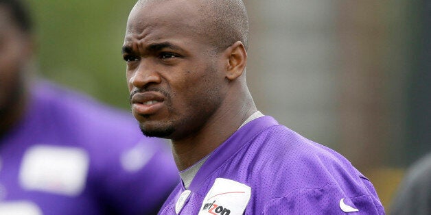 FILE - In this July 28, 2014, file photo, Minnesota Vikings running back Adrian Peterson looks on during NFL football training camp in Mankato, Minn. Peterson acknowledges he struck his young son with a branch, but insists he did not commit a crime. That belief is to draw further attention this week when the case against the Vikings' star running back goes before a Texas judge. (AP Photo/Charlie Neibergall, File)