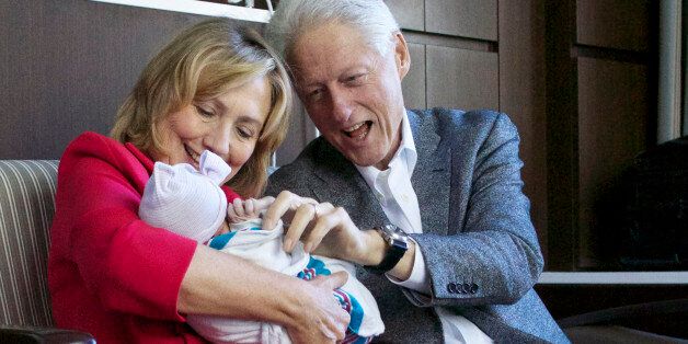 This photo provided by Clinton spokesman Kamyl Bazbaz shows former Secretary of State Hillary Rodham Clinton, left, and former President Bill Clinton, right with their granddaughter Charlotte Clinton Mezvinsky on Saturday, Sept. 27, 2014, at Lenox Hill Hospital in New York. The Clintons's daughter, Chelsea, gave birth Friday night to her first child, Charlotte. (AP Photo/Office of President Clinton, Jon Davidson)