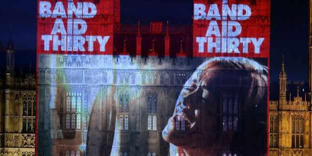 LONDON, ENGLAND - DECEMBER 07: Band Aid 30 is projected onto the The Palace of Westminster on December 7, 2014 in London, England. Band Aid 30 is a charity project set by Bob Geldof and Midge Ure to raise money to combat the ebola epidemic in West Africa. (Photo by Danny E. Martindale/Getty Images)