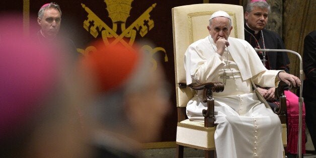 Pope Francis attends an audience of the Curia, the administrative apparatus of the Holy See, for Christmas greetings in the Sala Clementina of the Apostolic Palace at the Vatican, on December 22, 2014. AFP PHOTO / ANDREAS SOLARO (Photo credit should read ANDREAS SOLARO/AFP/Getty Images)