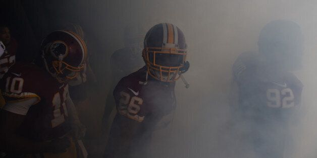 LANDOVER, MD - DECEMBER, 28: Washington Redskins quarterback Robert Griffin III (10), Washington Redskins cornerback Bashaud Breeland (26) and Washington Redskins nose tackle Chris Baker (92) in the smoke as they prepare for team introductions before playing the Dallas Cowboys at FedEx field on December 28, 2014 in Landover, MD. (Photo by Jonathan Newton / The Washington Post via Getty Images)
