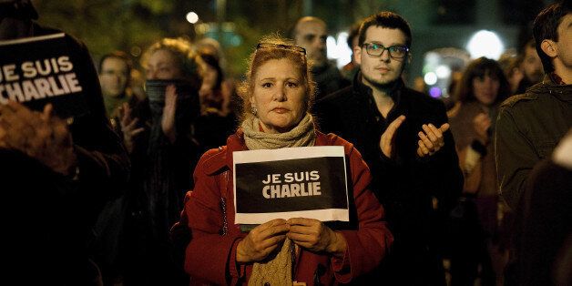 MADRID, SPAIN - JANUARY 07: A woman holds a placard reading 'Je Suis Charli' (I am Charlie) during a gathering of people showing their support for the victims of the terrorist attack at French magazine Charlie Hebdo, in front of the Embassy of France on January 7, 2015 in Madrid, Spain. Twelve people were killed, including two police officers, as two gunmen opened fire at the magazine offices of Charlie Hebdo in Paris, France. (Photo by Pablo Blazquez Dominguez/Getty Images)