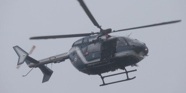 A helicopter of the French Gendarmerie flies over Dammartin-en-Goele where a hostage-taking was underway after police hunting the Islamist brothers who killed 12 people earlier this week exchanged fire with two men during a car chase, on January 9, 2015. Friday's drama unfolded almost 48 hours into a massive manhunt launched after the brothers burst into the office of the satirical weekly Charlie Hebdo and gunned down staff members and two policemen, saying they were taking revenge for the magazine's publication of cartoons offensive to many Muslims. The number of people seized was not immediately confirmed. AFP PHOTO / JOEL SAGET (Photo credit should read JOEL SAGET/AFP/Getty Images)