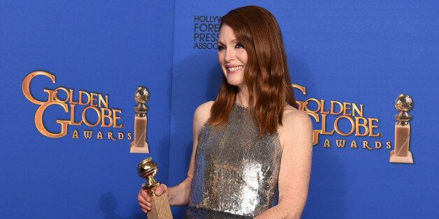 Julianne Moore poses in the press room with the award for best actress in a motion picture - drama for âStill Aliceâ at the 72nd annual Golden Globe Awards at the Beverly Hilton Hotel on Sunday, Jan. 11, 2015, in Beverly Hills, Calif. (Photo by Jordan Strauss/Invision/AP)