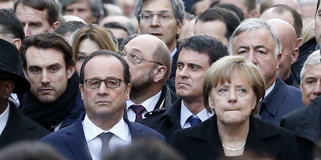 French President Francois Hollande and German Chancellor Angela Merkel march in Paris, France, Sunday, Jan. 11, 2015. Thousands of people began filling Franceâs iconic Republique plaza, and world leaders converged on Paris in a rally of defiance and sorrow on Sunday to honor the 17 victims of three days of bloodshed that left France on alert for more violence. (AP Photo/Michel Euler)