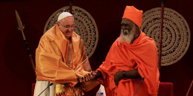 COLOMBO, SRI LANKA - JANUARY 13: A Sri Lankan Hindu priest Kurakkal SivaSri T. Mahadeva (R), presents a shawl to Pope Francis during the inter-religious encounter at Bandaranaike Memorial International Conference Hall on January 13, 2015 in Colombo, Sri Lanka. Pope Francis is visiting Sri Lanka from January 13th to January 15th as part of his second Asia tour in less than six months. The Pope's arrival comes shortly after former president Mahinda Rajapaksa's conceded victory to newly instated President Maithripala Sirisena. Pope Francis will travel to the Philippines following the Sri Lanka visit. (Photo by Buddhika Weerasinghe/Getty Images)