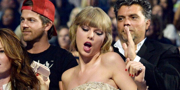 NASHVILLE, TN - JUNE 05: Musician Taylor Swift dances in the audience during the 2013 CMT Music Awards at the Bridgestone Arena on June 5, 2013 in Nashville, Tennessee. (Photo by Jeff Kravitz/FilmMagic)