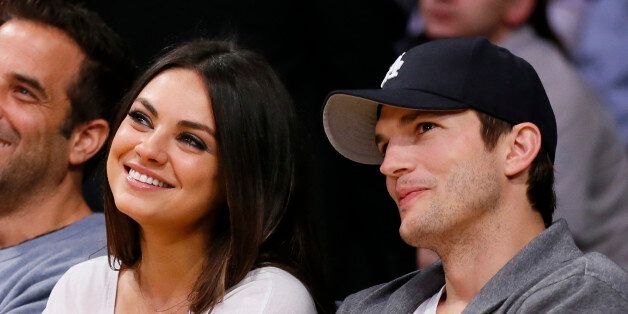 Actress Mila Kunis, left, and actor Ashton Kutcher, right, sit courtside together at the NBA basketball game between the Phoenix Suns and Los Angeles Lakers on Tuesday, February 12, 2013, in Los Angeles. (AP Photo/Danny Moloshok)