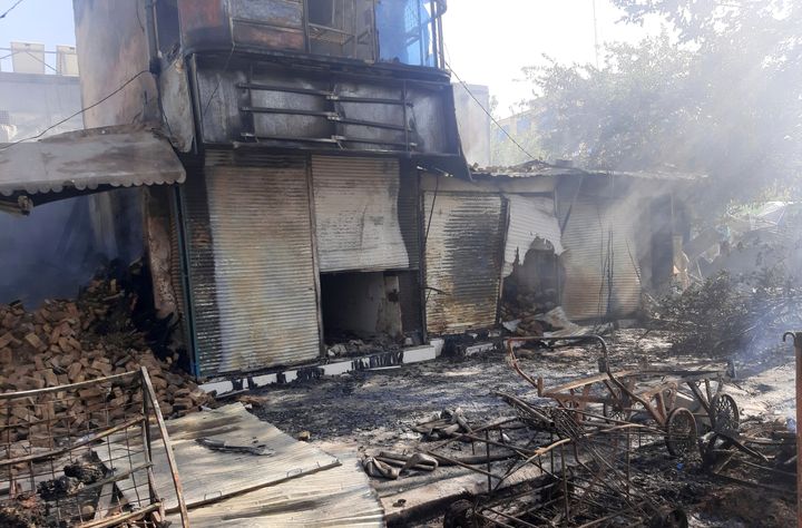 Smoke rises from damaged shops after fighting between Taliban and Afghan security forces in Kunduz city, northern Afghanistan