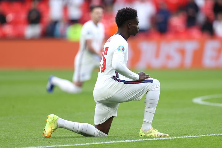 Bukayo Saka of England takes a knee in support of the Black Lives Matter movement before a UEFA Euro 2020 Championship match