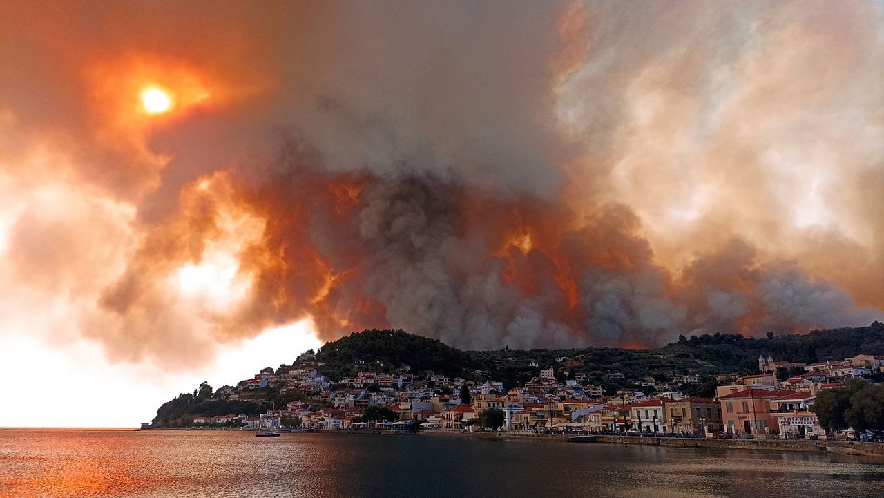 Flames spread across a mountain near Limni on the island of Evia, about 100 miles north of Athens, on Aug. 3. Greece grappled Tuesday with its worst heat wave in decades, which is straining the national power supply and fueling fires. 