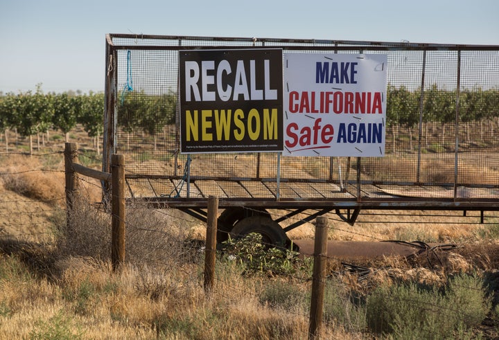 Signs supporting the Newsom recall are seen in Gustine, California.
