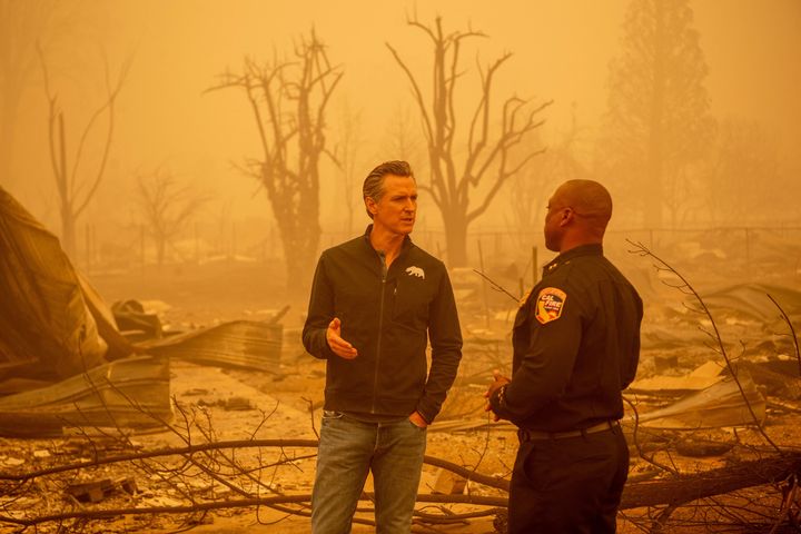 Newsom tours an area destroyed by wildfires in August.